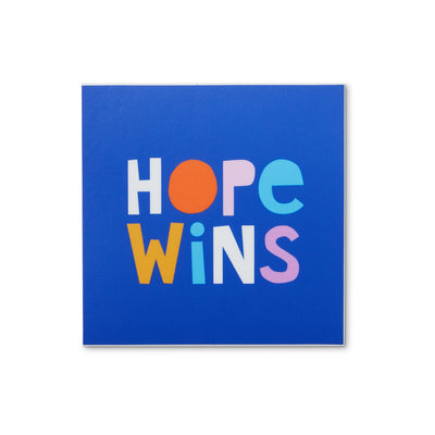 square blue sticker with colorful cut paper letters reads Hope Wins