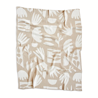 linen throw blanket with white cut paper shapes
